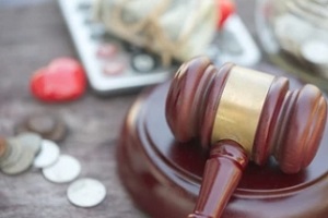 court gavel with calculator and coins in blur background