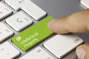 man pressing intellectual property key on keyboard
